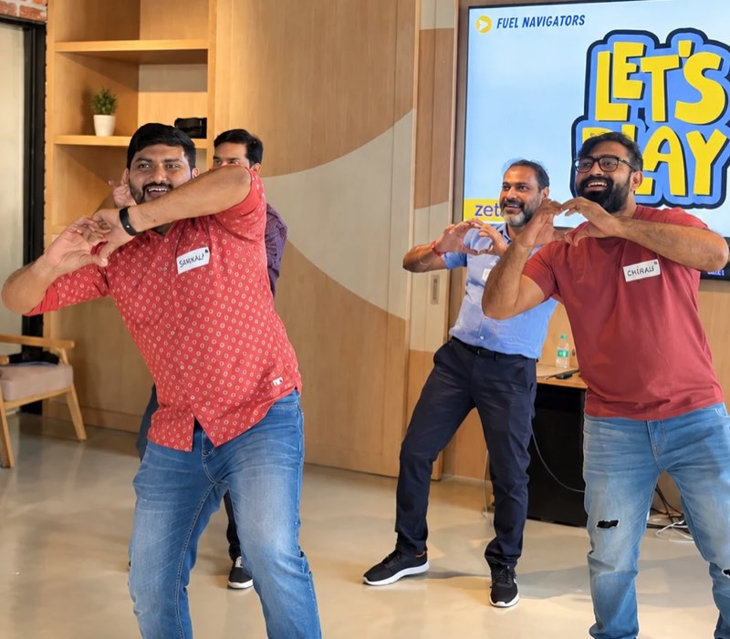 Four managers copying a gesture during a session, the words